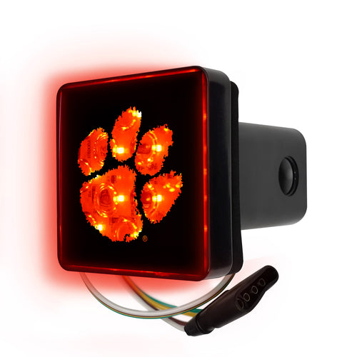 Clemson University lighted hitch cover by Logo Brands showing the illuminated Clemson logo on a vehicle hitch receiver.