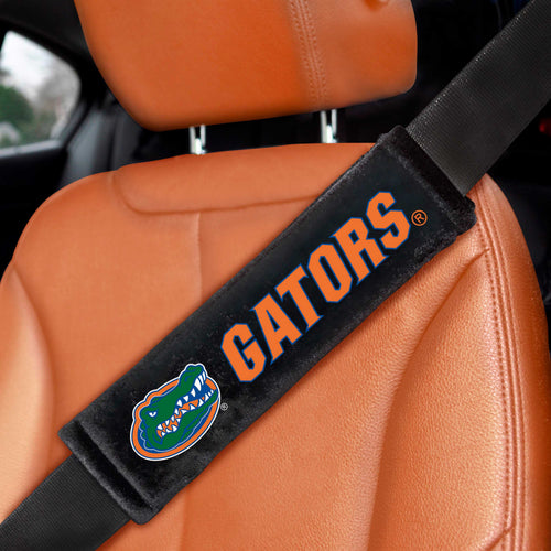 Pair of University of Florida embroidered auto seat belt pads by Logo Brands, featuring colorful UF logo and comfortable padding.