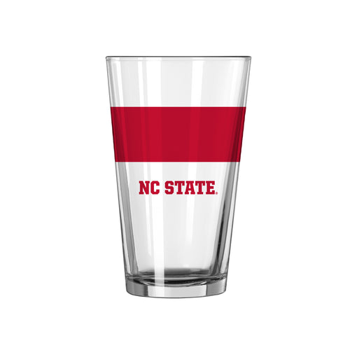 16oz NC State colorblock pint glass by Logo Brands, featuring bold team colors and logo on clear drinkware.