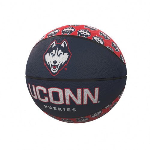 Mini rubber basketball featuring UConn repeating logo, ideal for recreation, by Logo Brands, shown in vibrant colors.