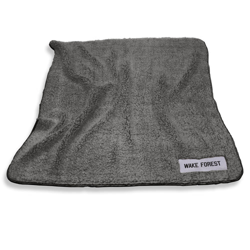 Wake Forest Frosty Fleece blanket by Logo Brands, featuring team colors and logo, soft and cozy for fans.